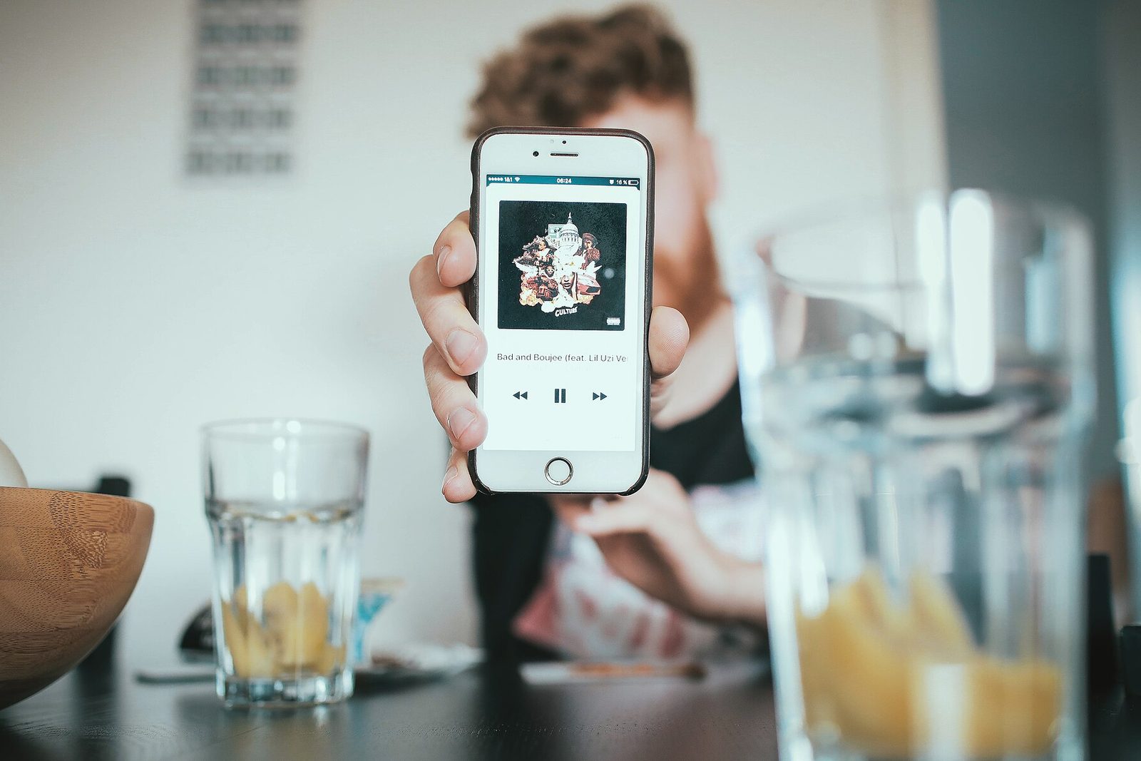 A close-up of a phone showing the Spotify for Artists pitch screen with genre and mood fields being filled in.