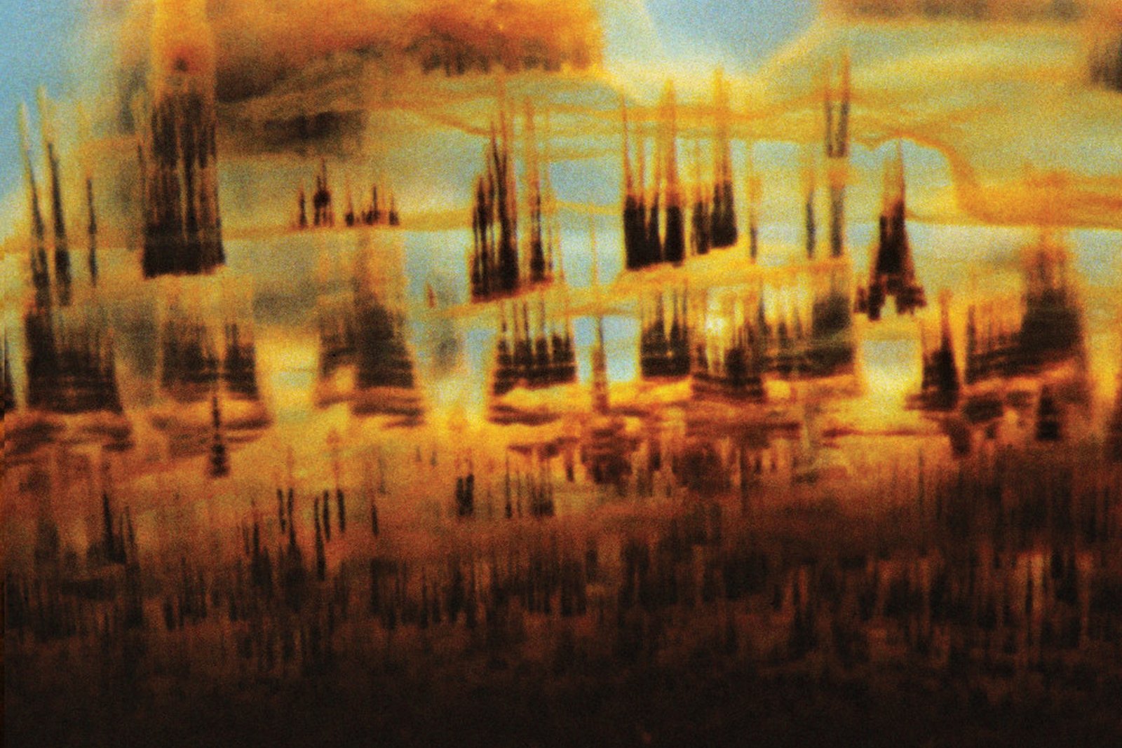 Album artwork for Bonobo's Distance In Static, golden spires dissolving into a deep red band