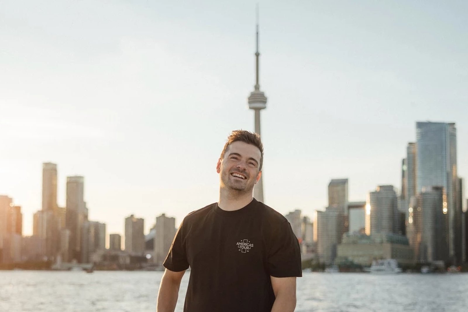 Martin Garrix in front of the Toronto skyline with the CN Tower behind him