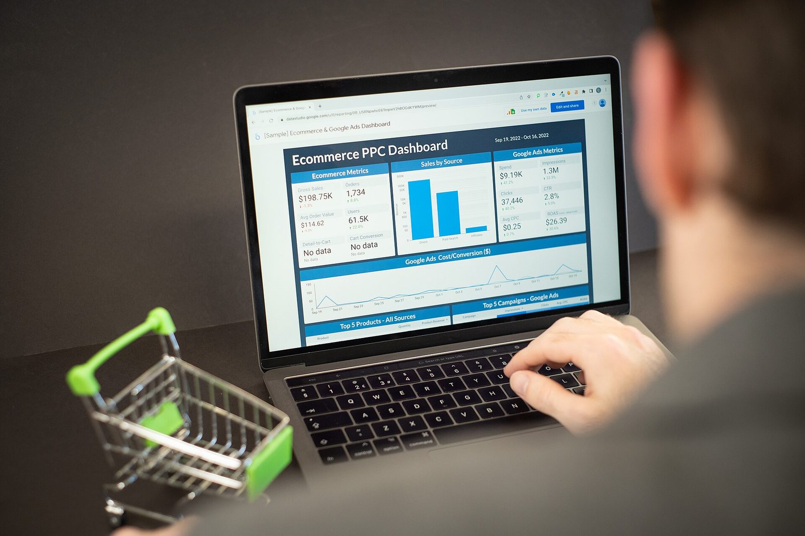 An independent musician reviewing a Spotify for Artists dashboard on a laptop in a home studio.